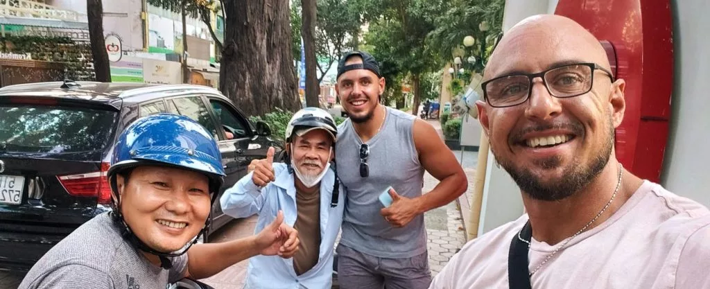 Two men pictured travelling with two locals all smiling at camera